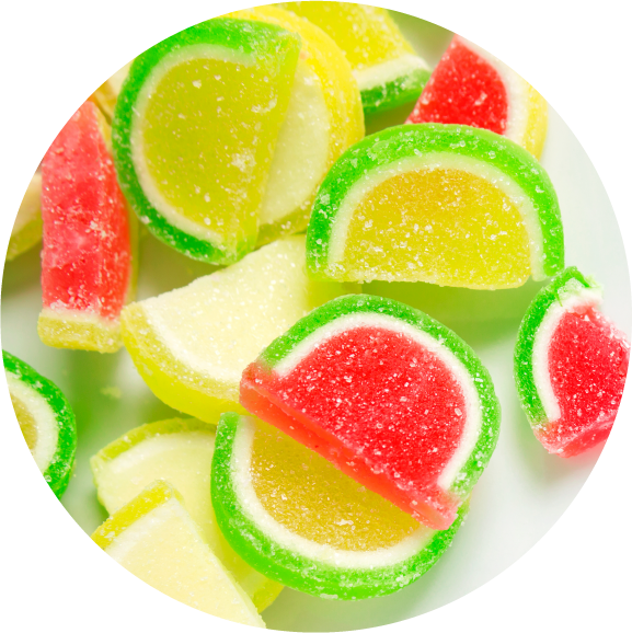 Close-up of colorful, fruit-shaped gummy candies coated in sugar